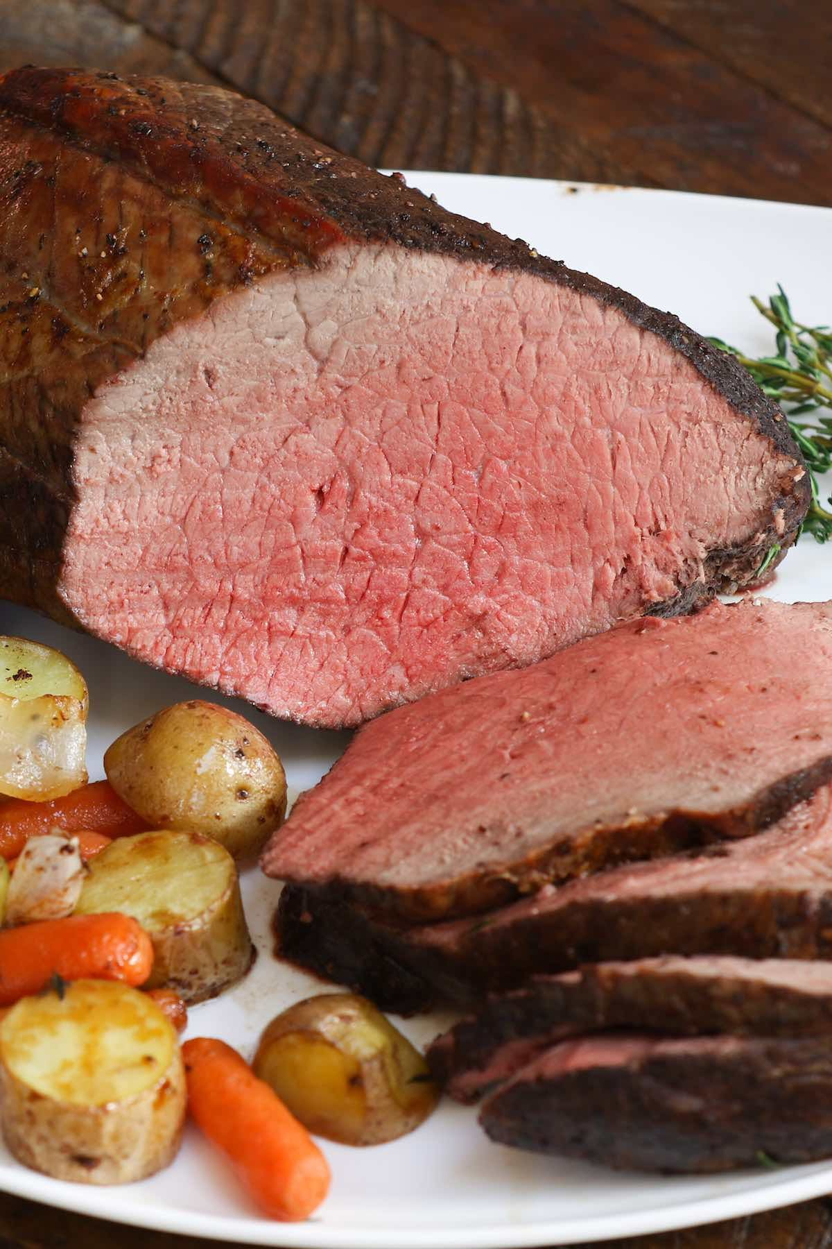 Slices Of Sirloin Tip Roast On A Serving Plate With Roasted Potatoes